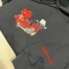 Black hoodie showing a stitched red touring motorcycle on the chest and Wildeman in red thread along the sleeve