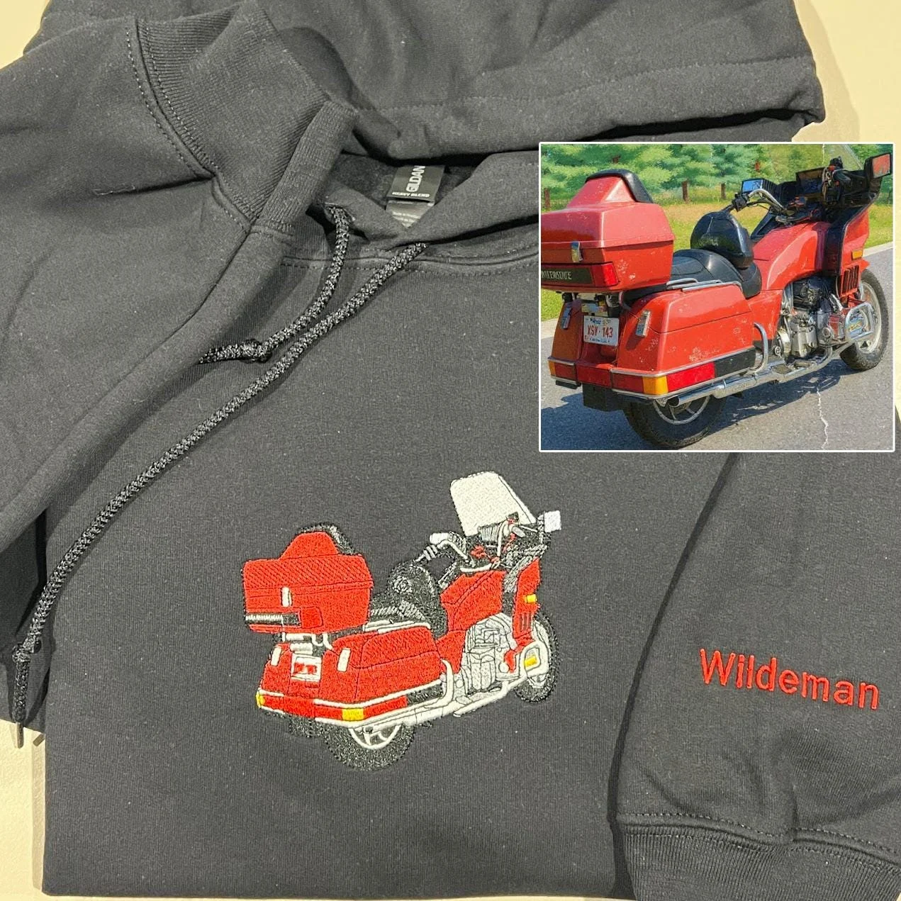 Black hoodie with a red touring motorcycle embroidered on the chest, the name Wildeman on the sleeve and the source photo