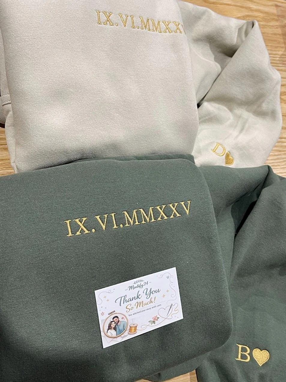 Light beige and military green pair with IX.VI.MMXXV in gold Roman numerals and gold D and B heart initials on the cuffs