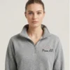 Woman wearing personalized nurse stethoscope embroidered quarter zip in heather grey with pink embroidery