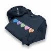 Navy sweatshirt with candy hearts spelling NURSE diagonally and the sleeve personalized with Liway RN