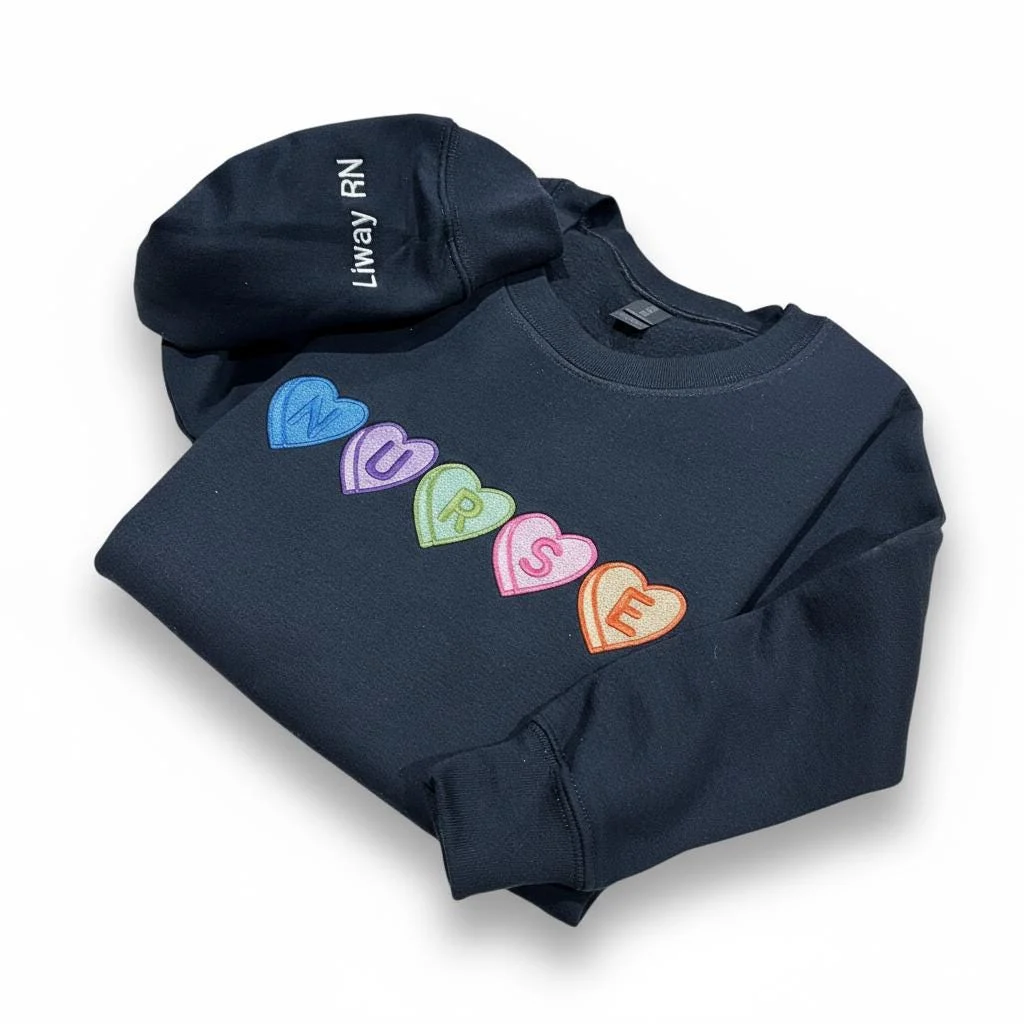 Navy sweatshirt with candy hearts spelling NURSE diagonally and the sleeve personalized with Liway RN