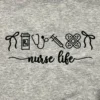 Straight-on close-up of the black nurse life script under a row of minimalist medical icons on grey