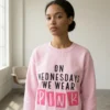 Woman wearing On Wednesdays We Wear Pink embroidered sweatshirt in light pink with statement embroidery