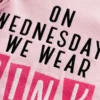 Close-up of embroidered text showing black ON WEDNESDAYS WE WEAR and hot pink PINK block letters