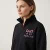 Personalized nurse bow stethoscope quarter zip front view on model showing left chest embroidery placement