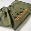 Folded military green Halloween crewneck with embroidered black cats on jack-o'-lanterns