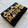 Folded black nurse Halloween crewneck with Code Boo in the ER embroidery