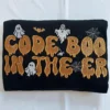 Code Boo in the ER embroidered design with ghosts, bats and spider webs on a black sweatshirt