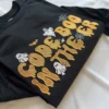 Black Code Boo in the ER sweatshirt with orange embroidered lettering, ghosts and spider webs