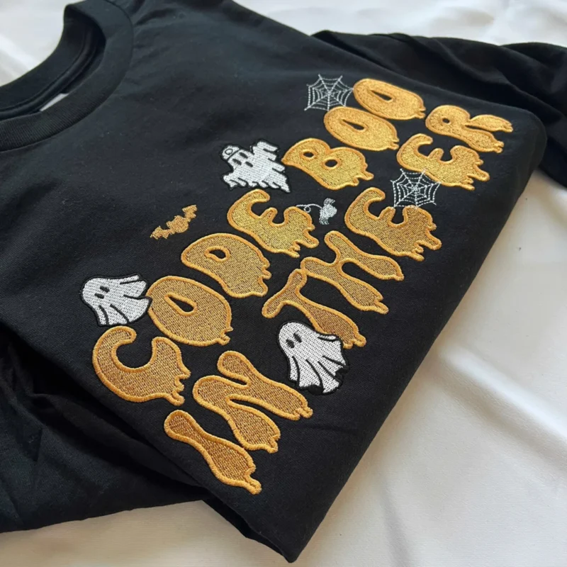 Black Code Boo in the ER sweatshirt with orange embroidered lettering, ghosts and spider webs
