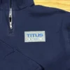 Navy quarter-zip with a rectangular company logo in blue, grey and white embroidered on the left chest