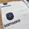 White quarter-zips with a navy owl icon and lowercase company wordmark embroidered on the left chest