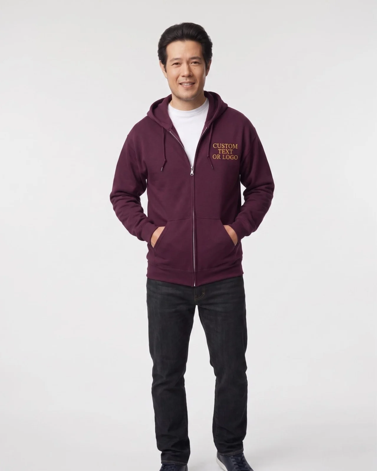 Man standing in a maroon full-zip hoodie and jeans with gold placeholder logo text on the left chest