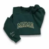 Forest green sweatshirt with arched cream varsity MAMA letters and the names Stephen and Josie in script on the sleeve