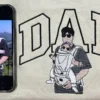 Dad portrait embroidery on a cream sweatshirt: black outline DAD and a dad carrying his baby, beside the source photo