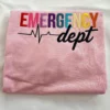 Folded light pink sweatshirt with rainbow EMERGENCY letters, a black heartbeat line and dept in black script