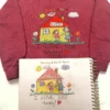 Maroon sweatshirt with a child’s house, mom and daughter and I LOVE YOU Mommy stitched, above the original drawing