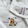 White sweatshirt with nana bear in purple script, the honey pot bear, and Aurelia and Ayden in purple on the sleeve