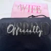 Matching pair of pink WIFE and black HUSBAND hoodies stacked, each with Officially embroidered in script