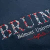 Navy sweatshirt with a team name in red and white floral letters, the university name and Softball in red script